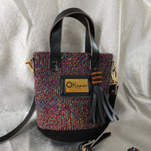 The small size of this stunning Okapu bag makes it an excellent 'going out' companion. Blue hues say 'I am cool' and this unique kiondo bag is sure to complement any of the fits in your closet, for both day and night activities.  Its black leather trimmings include an adjustable strap to carry it over your shoulder or across your body. With the removable straps, you could just easily grab it with your hands with the top handles. 