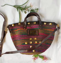 Top handle kiondo with studs.Okapu is a social enterprise making kiondos great. African bags handmade in Kenya with love for gifting and for elevating your fashion style.