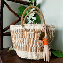 Neutral/ Nude top handle kiondo okapu with beaded round handles. Holiday or Vacation bag. Okapu is a social enterprise making kiondos great. African bags handmade in Kenya with love for gifts for women and to elevate their fashion style.